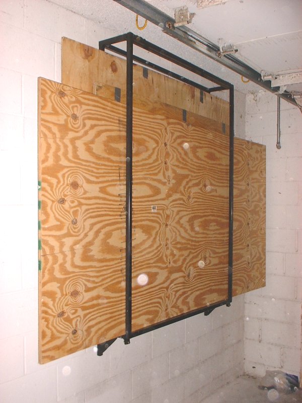 Custom wallmounted hurricane plywood storage rack Kurt