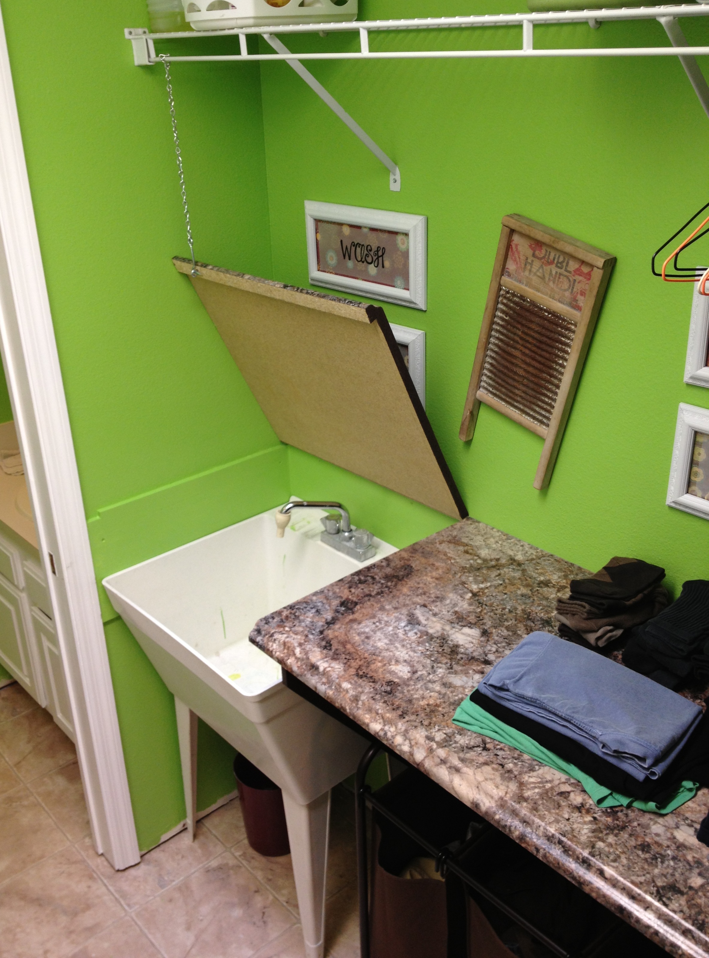 Laundry folding countertop hinges open to reveal utility sink 3