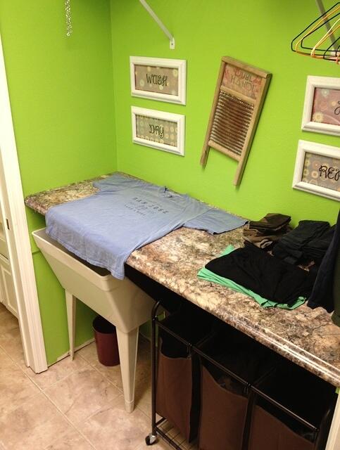 Laundry folding countertop hinges open to reveal utility sink 2