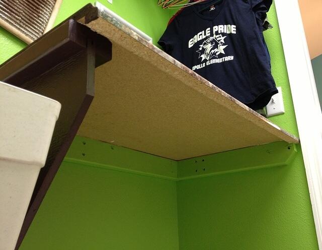 Laundry folding countertop hinges open to reveal utility sink 7