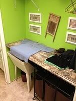 Laundry folding countertop hinges open to reveal utility sink 2