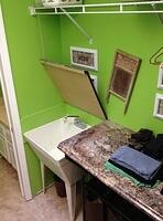 Laundry folding countertop hinges open to reveal utility sink 3