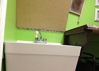 Laundry folding countertop hinges open to reveal utility sink 4