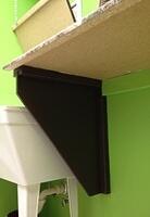 Laundry folding countertop hinges open to reveal utility sink 6