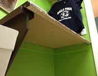 Laundry folding countertop hinges open to reveal utility sink 7